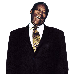 B.B. King laughing, wearing a black suit and a patterned tie.