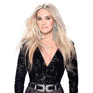Carrie Underwood with long blonde hair wearing a black sequined top and a silver belt.