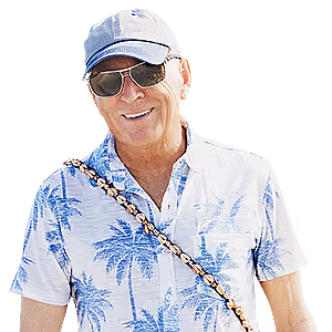 An older man wearing a baseball cap, sunglasses, and a palm tree print shirt with a shell necklace draped over his shoulder.