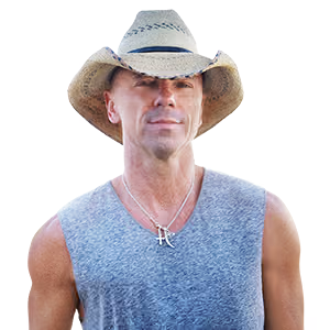A man wearing a cowboy hat and a sleeveless shirt with a silver pendant necklace.
